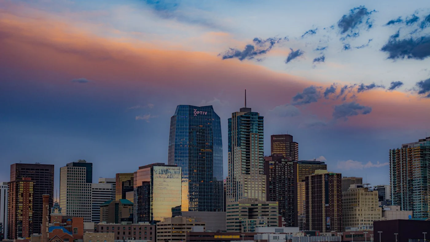 The downtown Denver skyline at sunset under pink and blue cloud