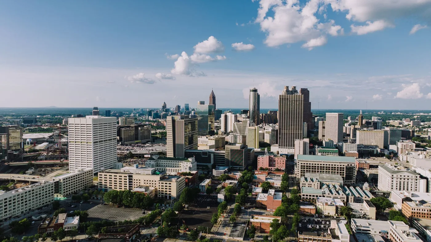 Aerial view of the Atlanta skyline under a clear blue sky
