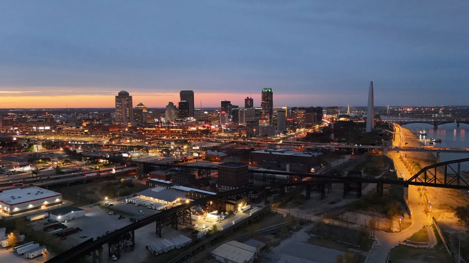 The St. Louis skyline and the Gateway Arch at dusk, with the Mississippi River beyond