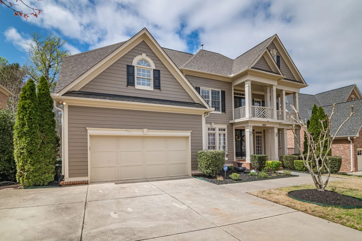 A suburban home with a spacious front garage and manicured lawns.