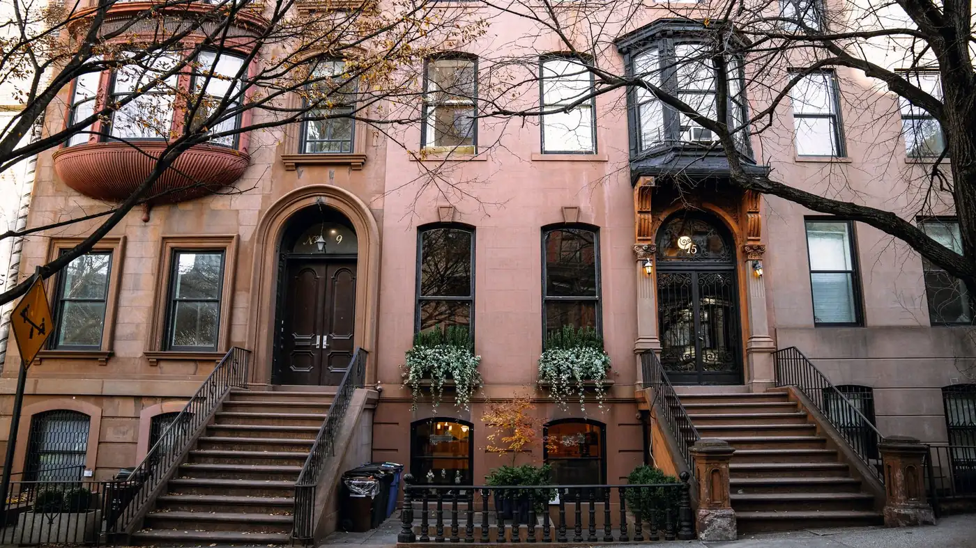 Brownstone houses with stoops on a Brooklyn street in autumn