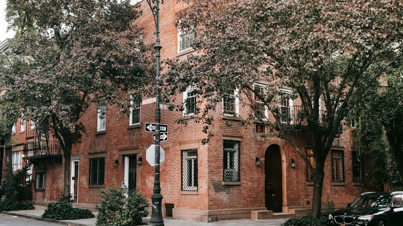 Older brick houses on a corner of Waverly Place in New York City