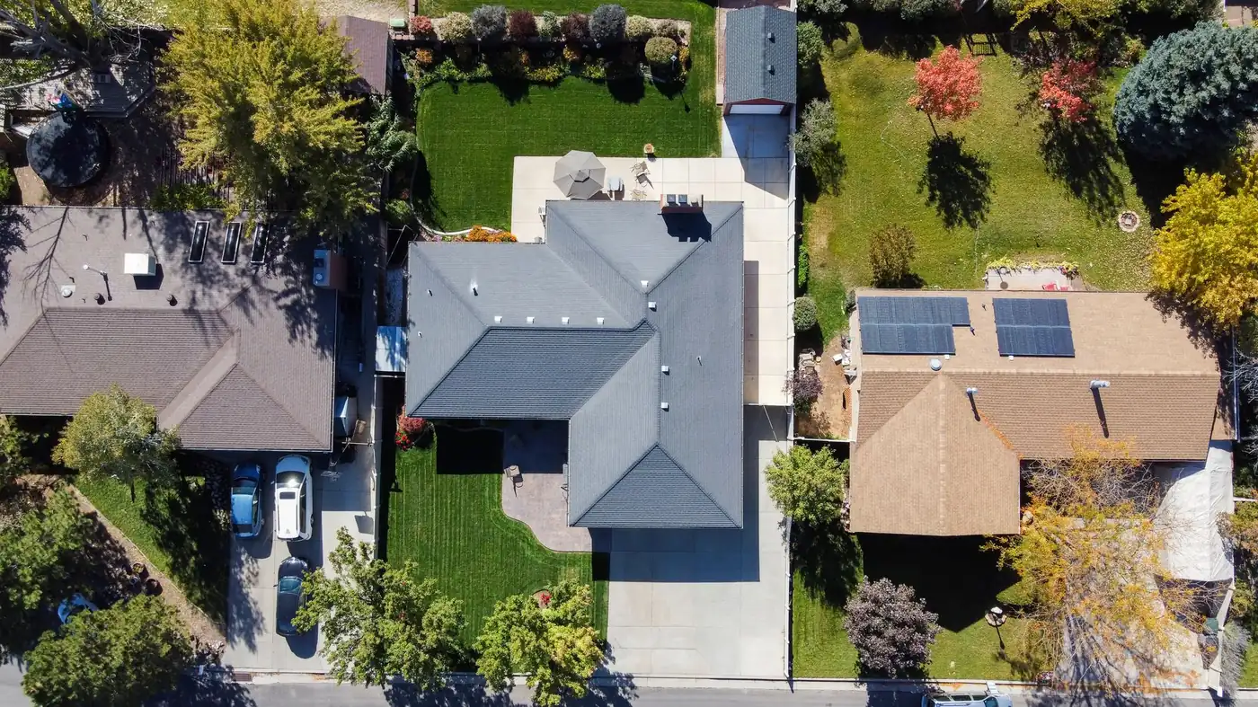 Overhead view of suburban houses showing roofs, solar panels, driveways and back gardens