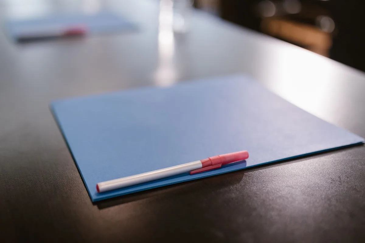 Blue document folder with a pen resting on a table